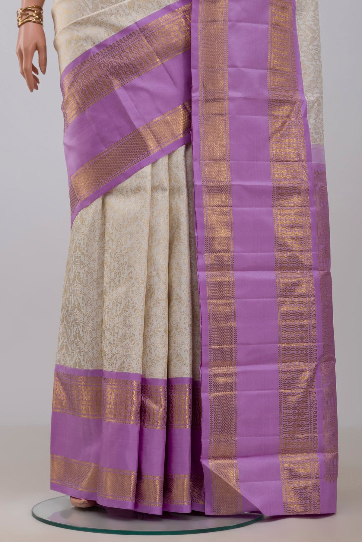 Pleats and pallu of Off White Kanchipuram Silk Saree with Zari Brocade on the body and Zari Border. 