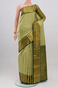 Light Green Kanchipuram Silk Saree with Zari Butta on the body and Zari Border.  displayed on a mannequin