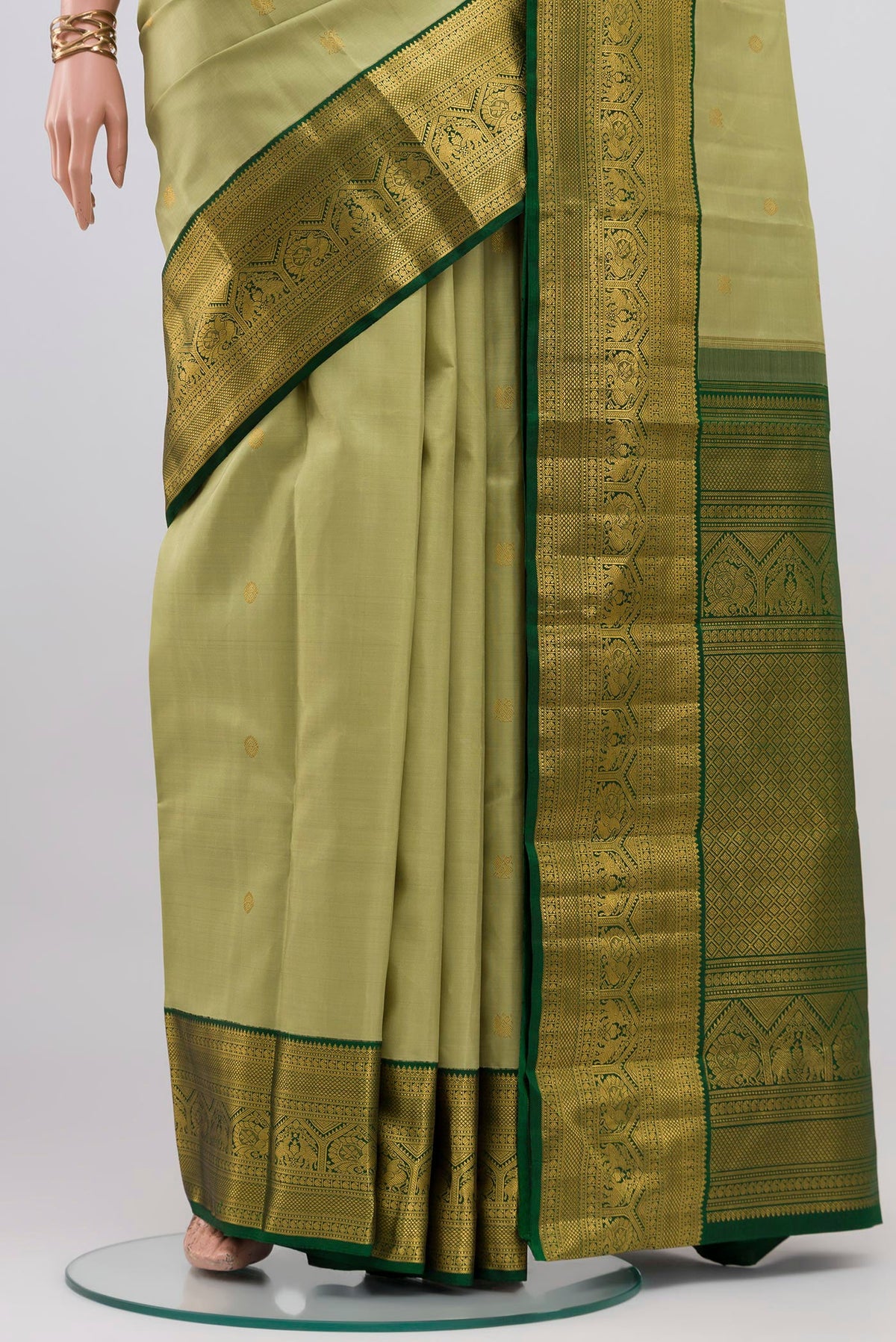 Pleats and pallu of Light Green Kanchipuram Silk Saree with Zari Butta on the body and Zari Border. 
