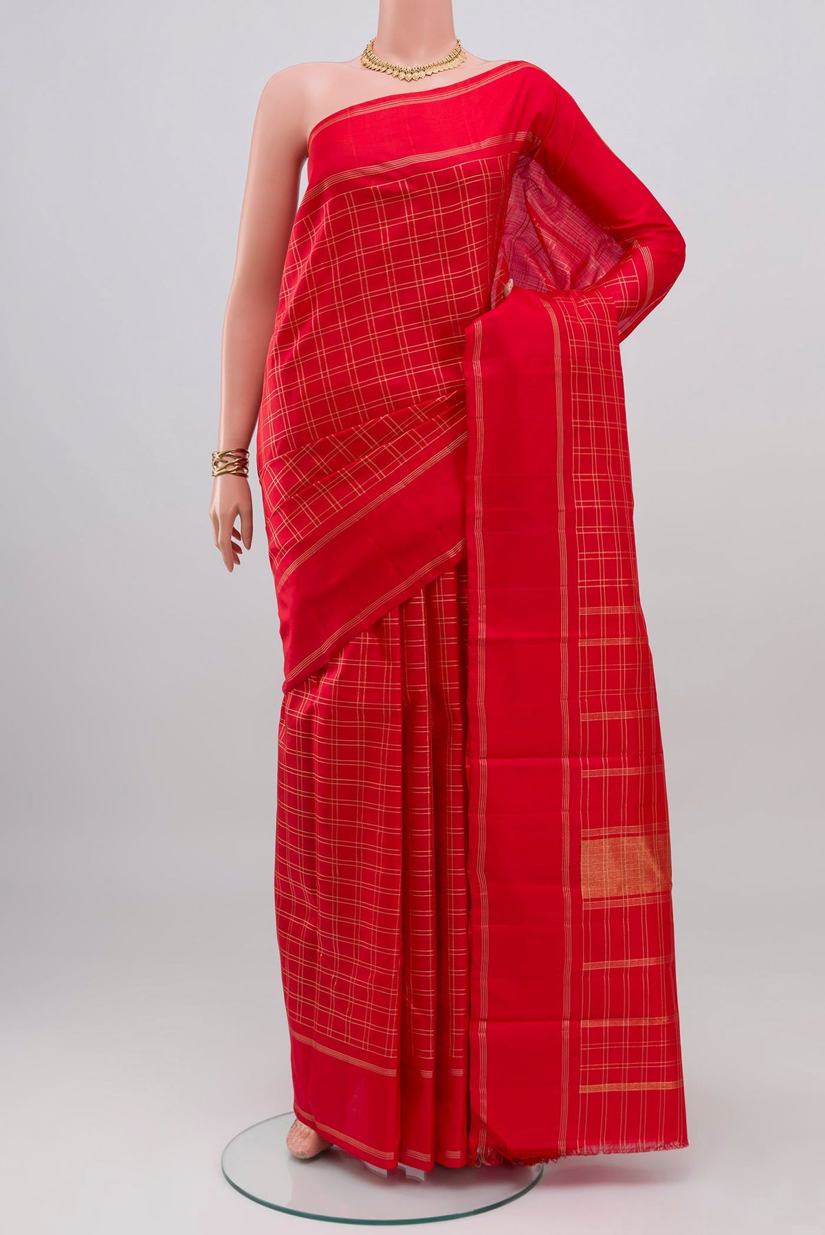 Red Kanchipuram Silk Saree with Checked design on the body and Plain Border.  displayed on a mannequin