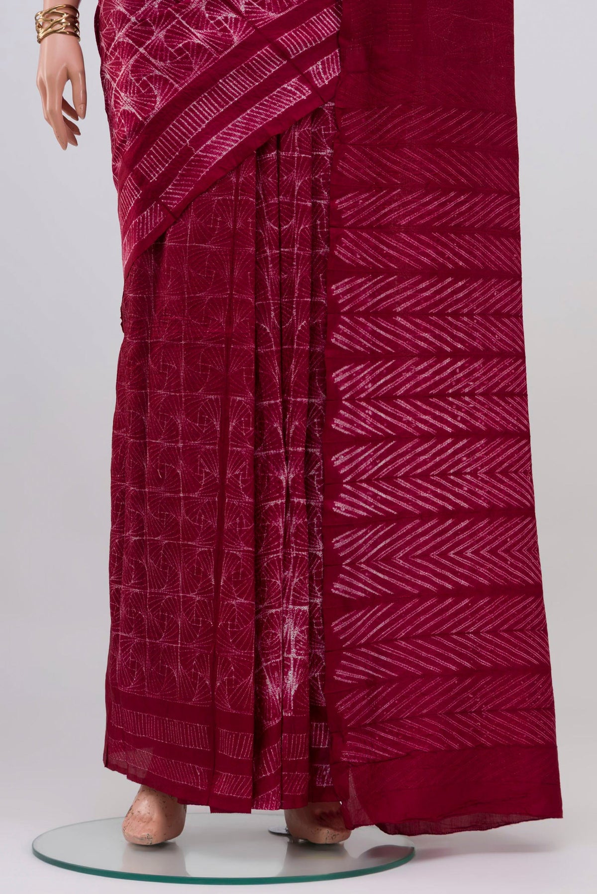Pleats and pallu of Maroon Tussar Silk Saree with Printed design on the body and Printed Border. 