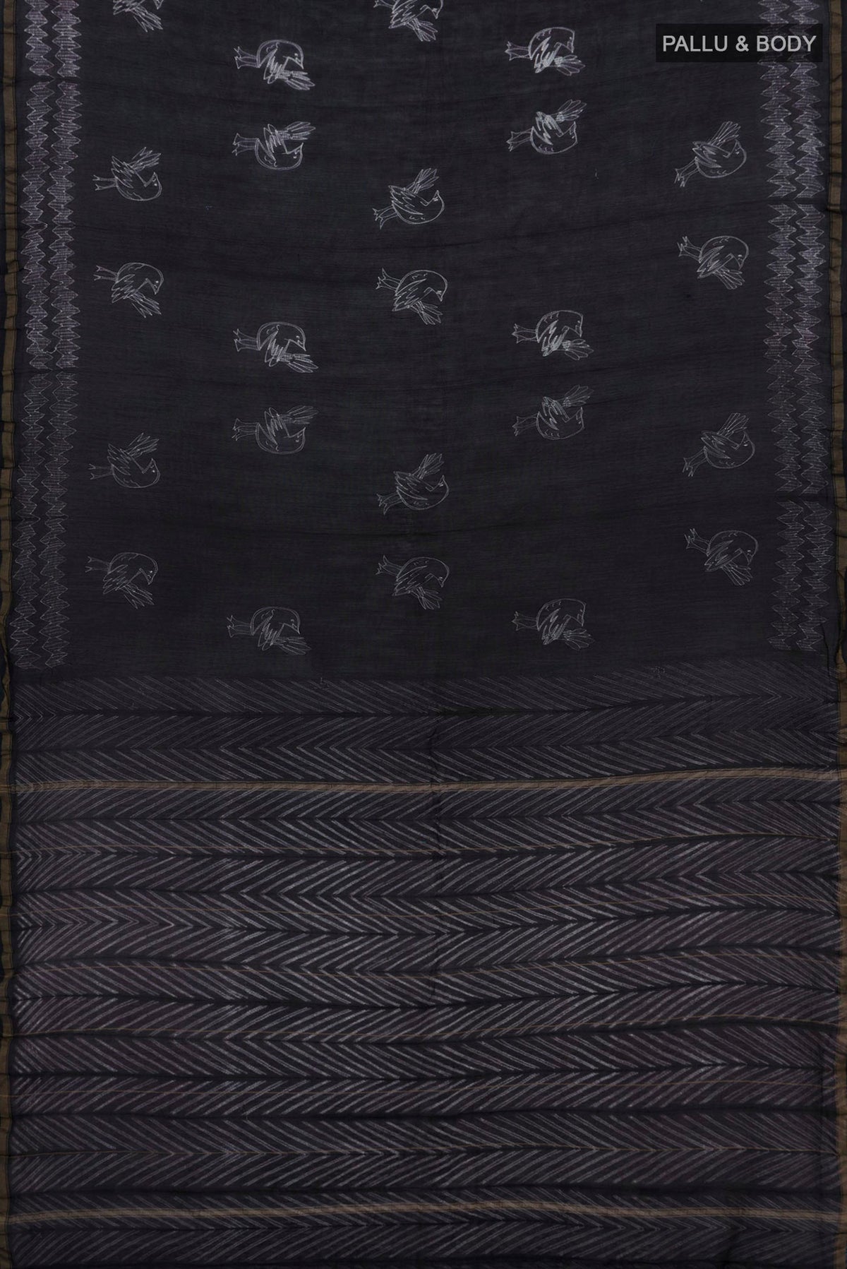 Flat view of Black Chanderi Silk Cotton Saree with Printed design on the body and Thin Zari Line. 