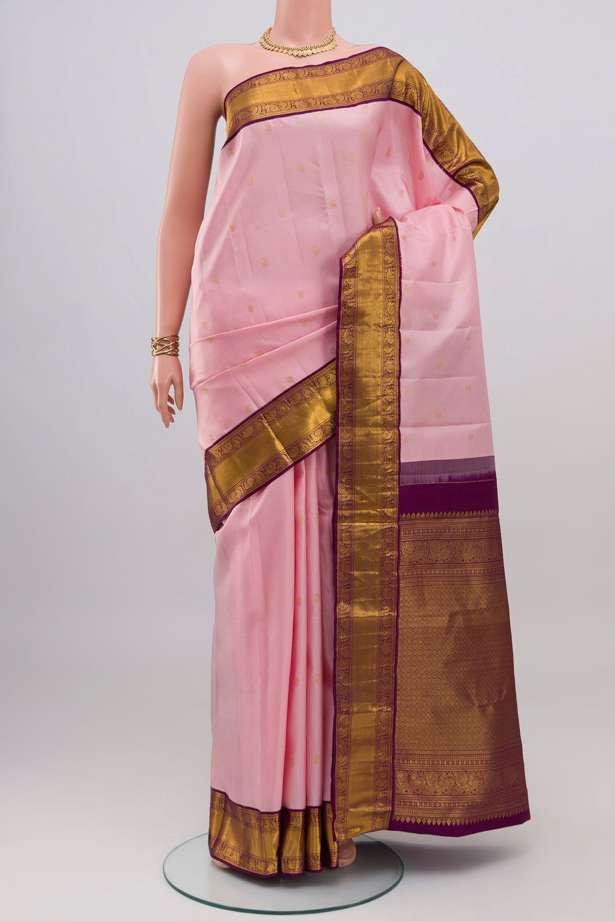 Rose pink Kanjivaram Silk Saree with Zari Butta on the body and Zari Border.  displayed on a mannequin