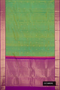 Green Dual Tone Kanchipuram Silk Saree with Zari Butta on the body and Zari Border.  displayed on a mannequin