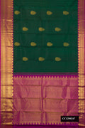 Green Dual Tone Kanchipuram Silk Saree with Zari Butta on the body and Zari Border.  displayed on a mannequin
