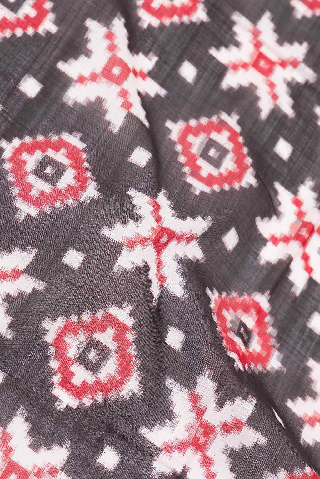 Close up of Black Dual Tone Double Ikat Saree with Ikat Print on the body and Plain Border displaying folds
