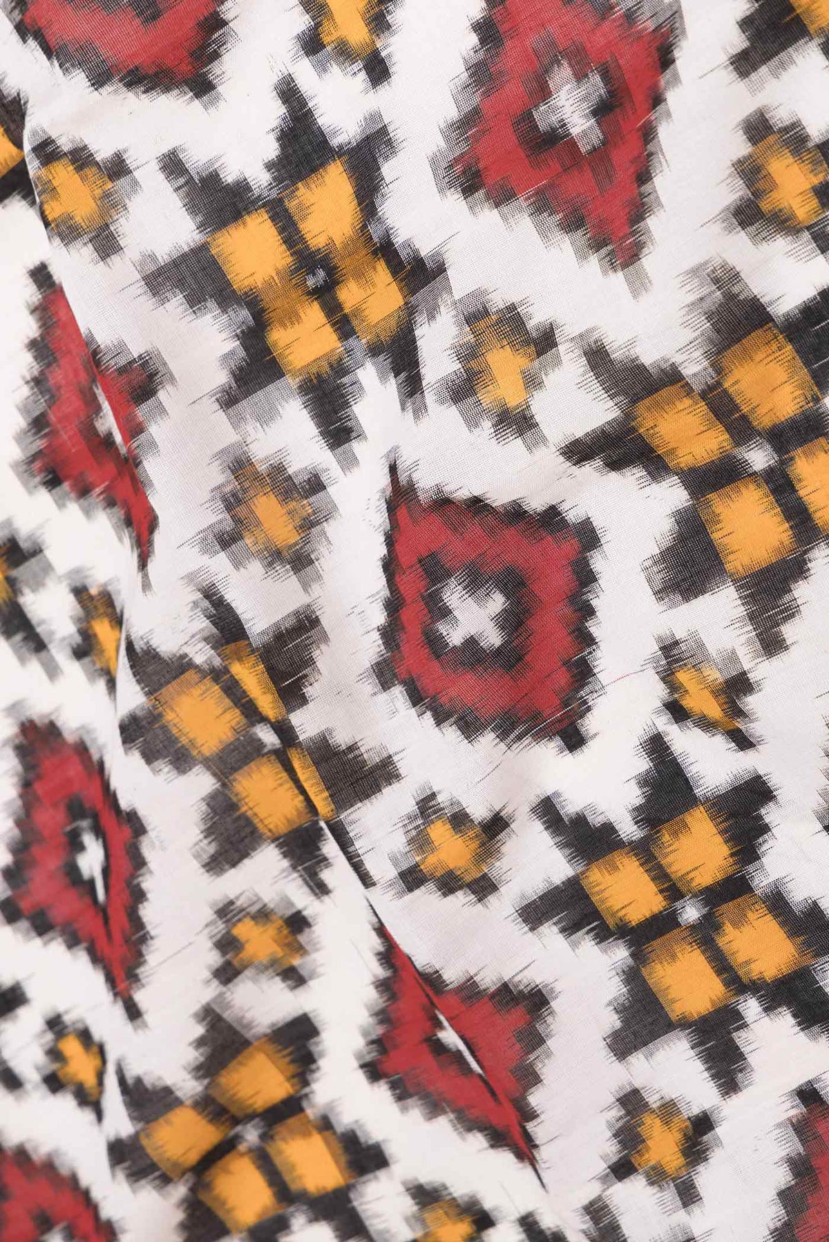 Close up of Off White Dual Tone Double Ikat Saree with Ikat Print on the body and Plain Border displaying folds
