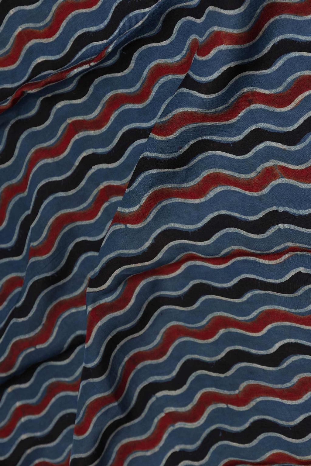 Close up of Blue Dual Tone Tussar Silk Saree with Printed design on the body and Zari Border displaying folds