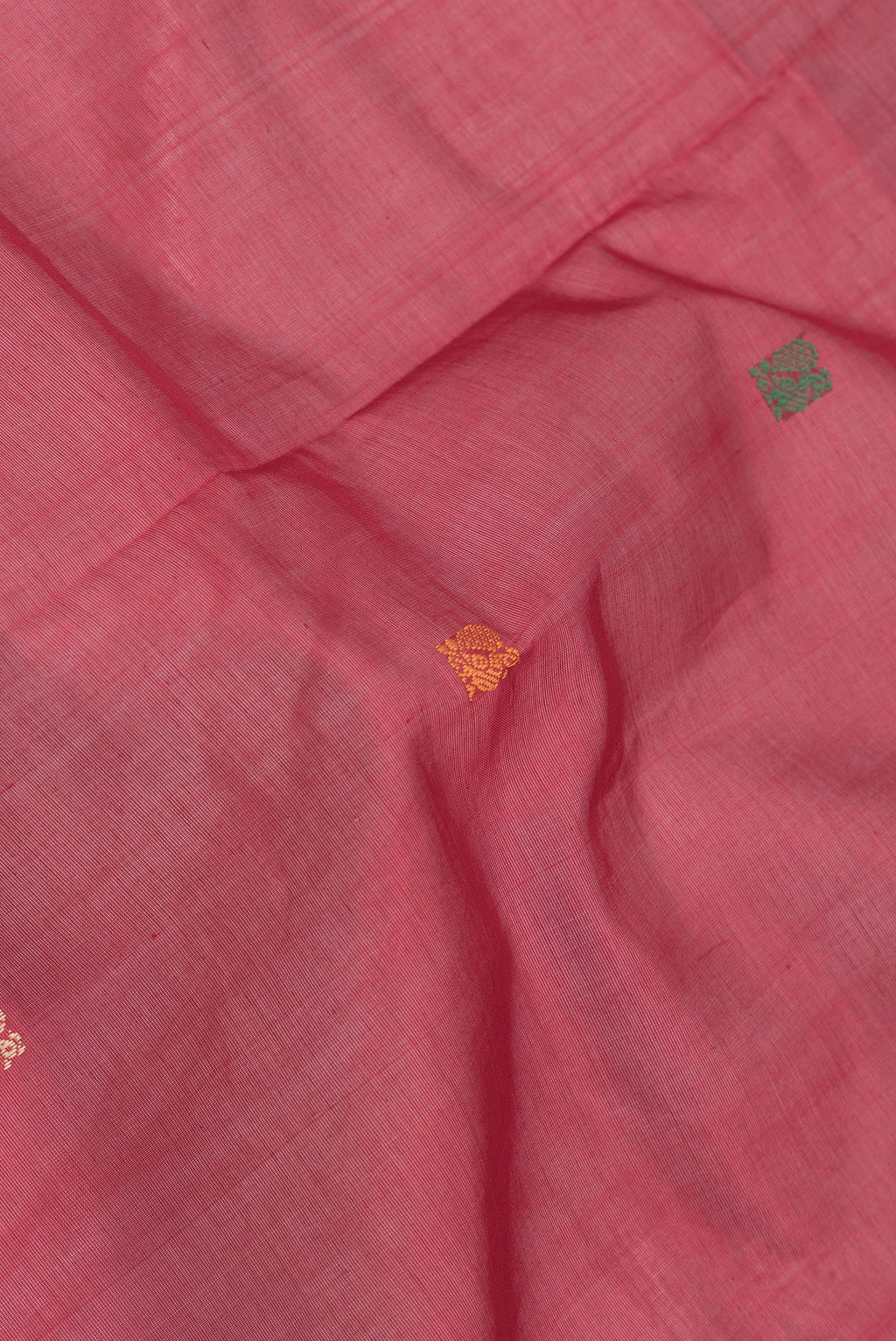 Close up of Red Dual Tone Silk Cotton Saree with Thread Butta on the body and Thread Border.  displaying folds