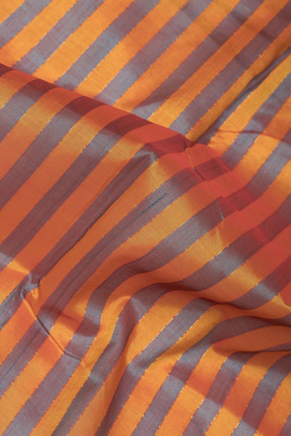 Close up of Yellow and Green Color Silk Cotton Saree with Stripes on the body and Zari Border.  displaying folds