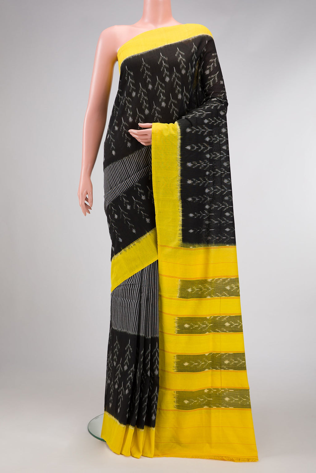 Black Dual Tone Double Ikat Saree with Ikat Print on the body and Plain Border.  displayed on a mannequin