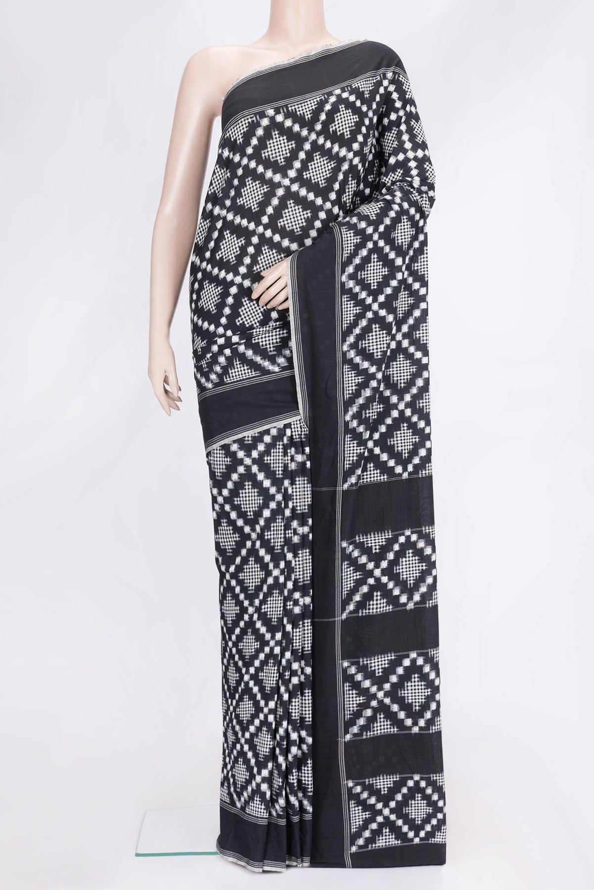 Black Dual Tone Double Ikat Saree with Ikat Print on the body and Plain Border.  displayed on a mannequin