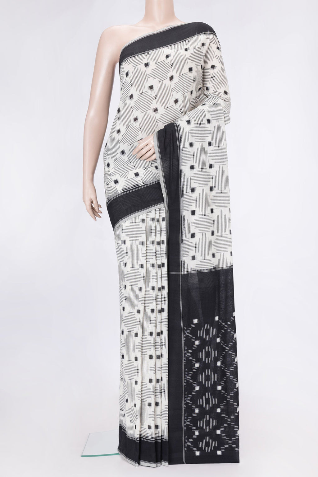 Off White Dual Tone Double Ikat Saree with Ikat Print on the body and Thread Border.  displayed on a mannequin