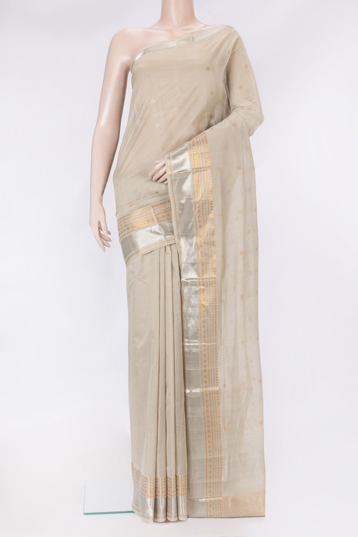 Beige Uppada Cotton Saree with Zari Butta on the body and Zari Border.  displayed on a mannequin