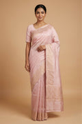 Model wearing a Mandhara, handwoven in Katan silk, brings together kadhua weaving and delicate meenakari detailing. Crafted in gold zari with silver accents, the saree draws from Art Nouveau florals and the concentric forms of Dhokra metal craft. Wavy, concentric borders with floral vines frame the design, while tiny silver-meenakari butis dot the body. The pallu completes the saree with elongated floral panels, lending a balanced, composed finish.