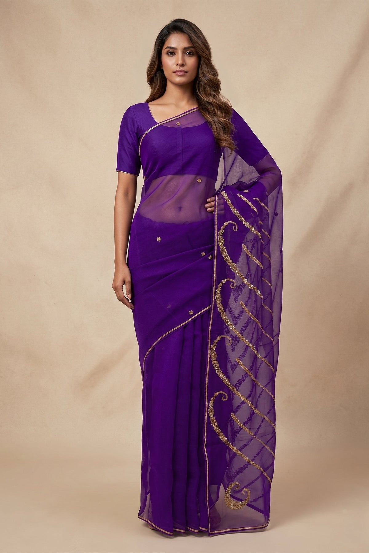 Model wearing a Sitara, crafted in silk organza and embroidered in antique-gold zardozi, draws from Art Nouveau?s love for organic, nature-led forms and the graceful contours of butterfly wings. The pallu features striking V-shaped motifs filled with floral embroidery, worked in dabka, sequins, and beads, alternating between dense and lighter forms. A minimal floral body allows the statement pallu to unfold with soft grandeur.