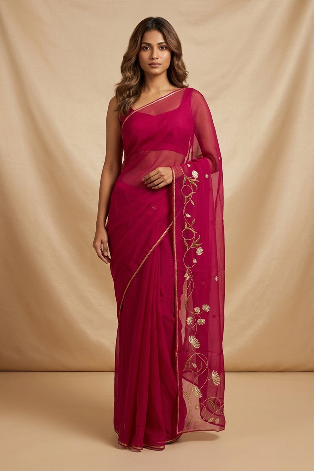 Model wearing a Bahar, crafted in silk organza, features delicate pani-zari enriched with zardozi, gota work, and dabka embroidery. Its defining element is an off-center floral vine running vertically through the body, breaking symmetry with quiet intent. Inspired by Art Nouveau?s flowing lines, the vine is rendered in slender leaves, zari chain-stitched stems, and alternating gota and zardozi flowers. The pallu trails gently onto the body in scattered embroidered blooms.