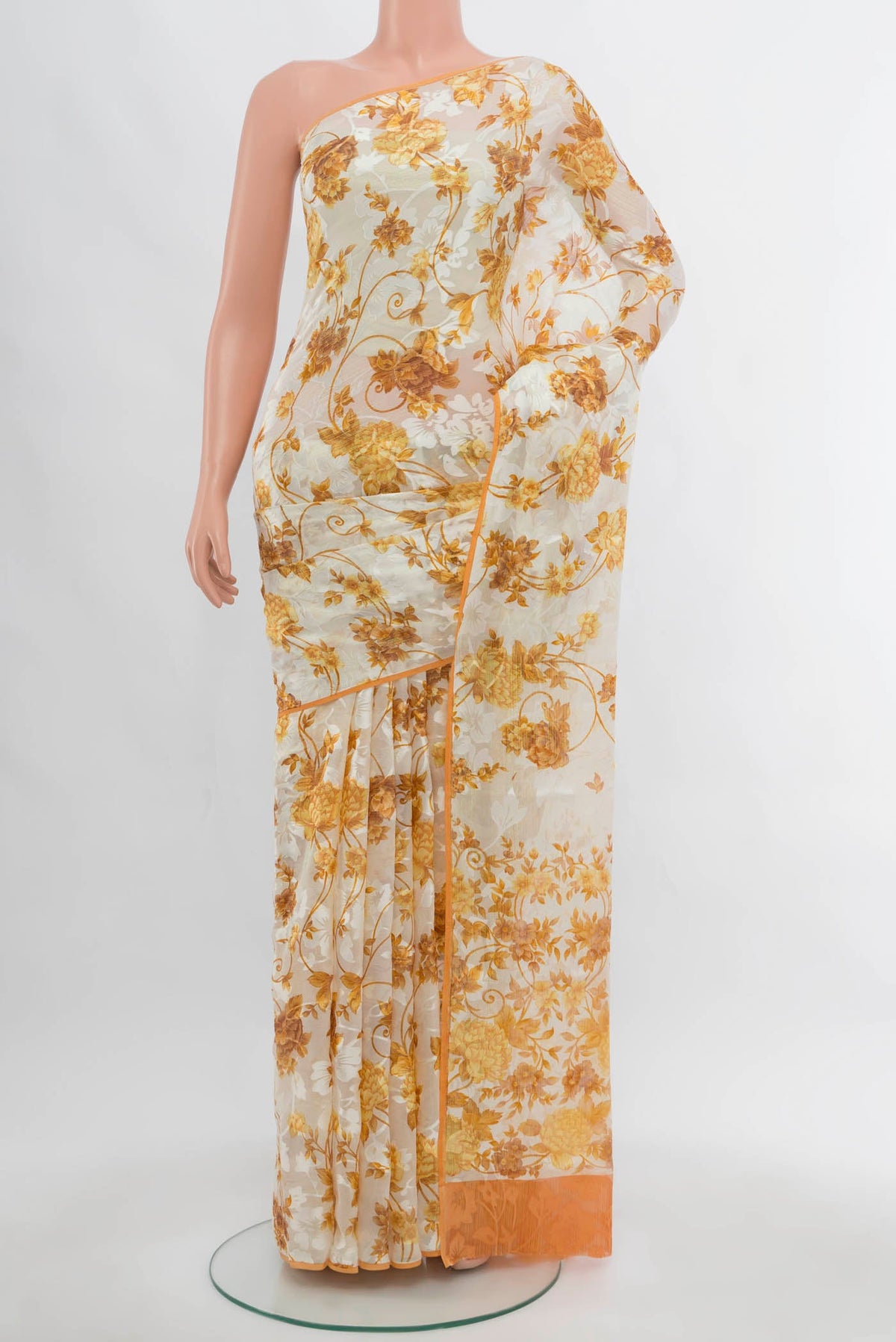 Off White Chiffon Saree with Zari Butta on the body and Silk Border.  displayed on a mannequin