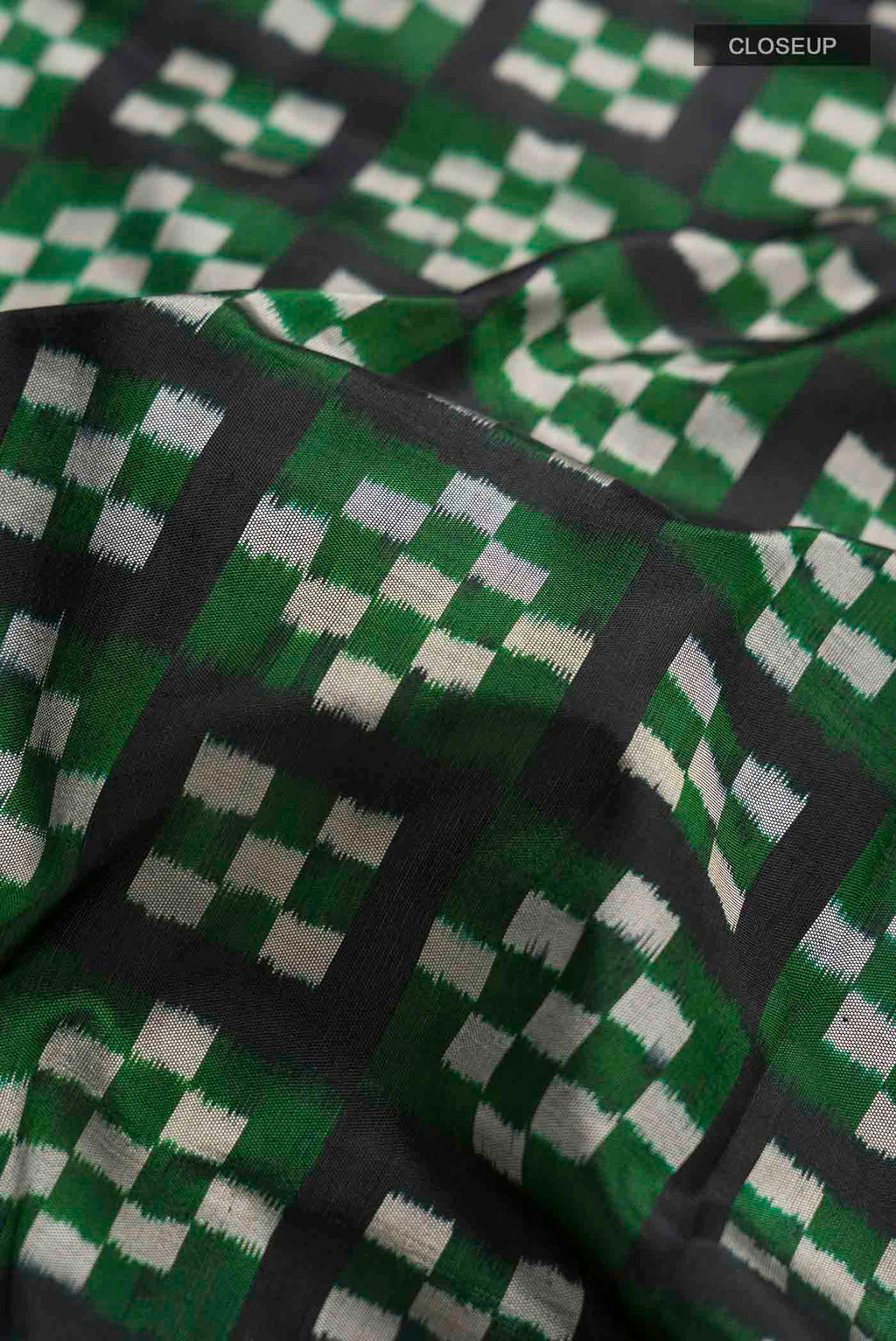Close up of Multi Color Pochampally Silk Saree with Pure Ikat on the body and Ikat Border displaying folds