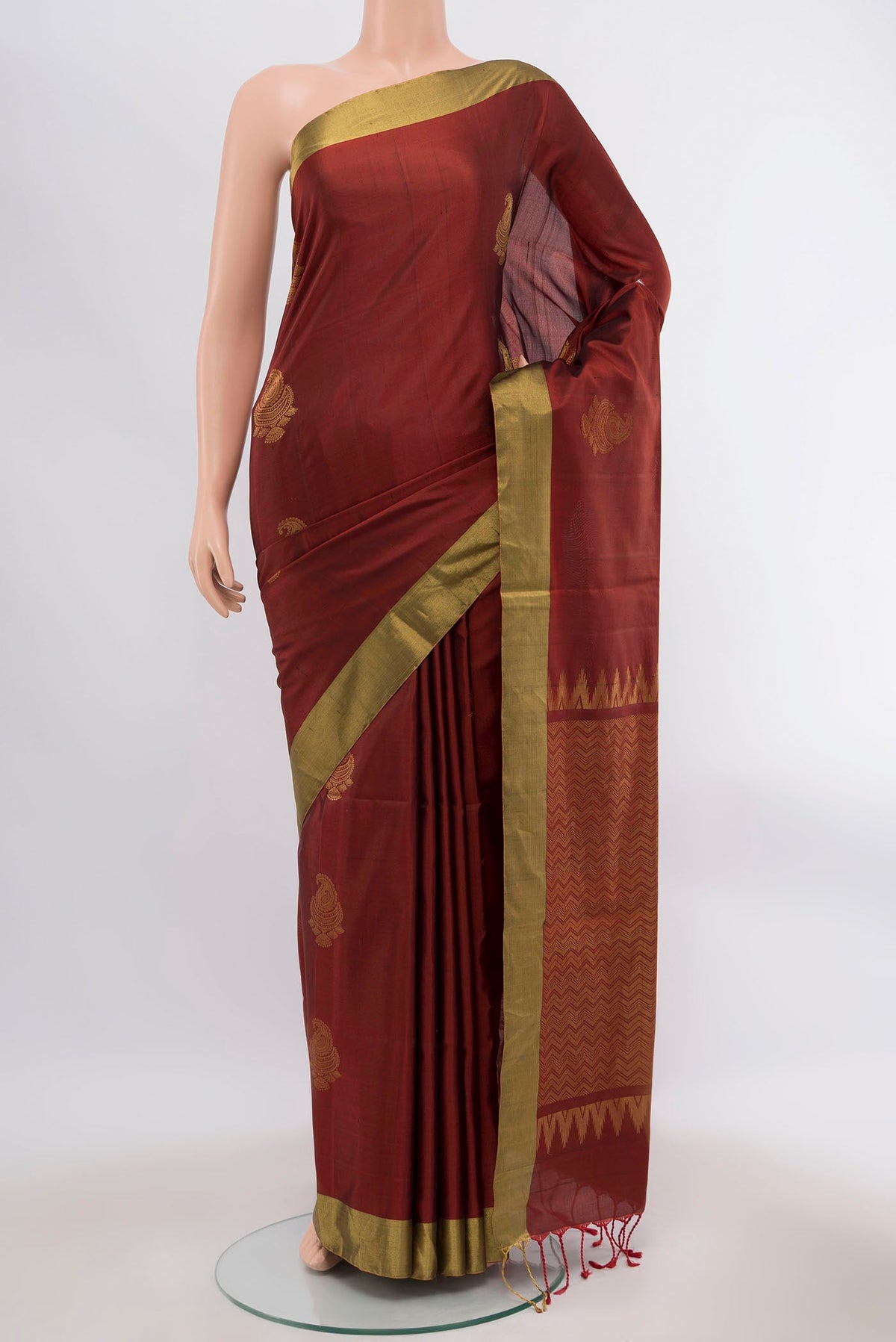 Brown Soft Silk Saree with Zari Butta on the body and Zari Border displayed on a mannequin