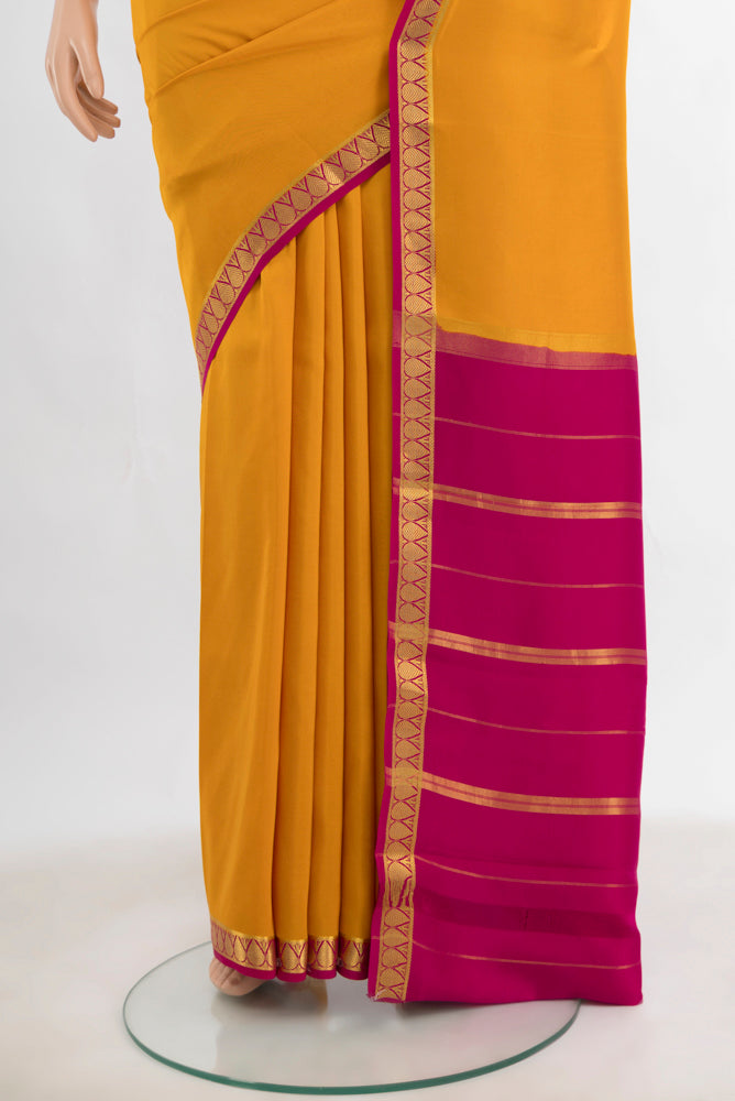 Pleats and pallu of Yellow Mysore Crepe Saree with Plain Body and Silk Border. 