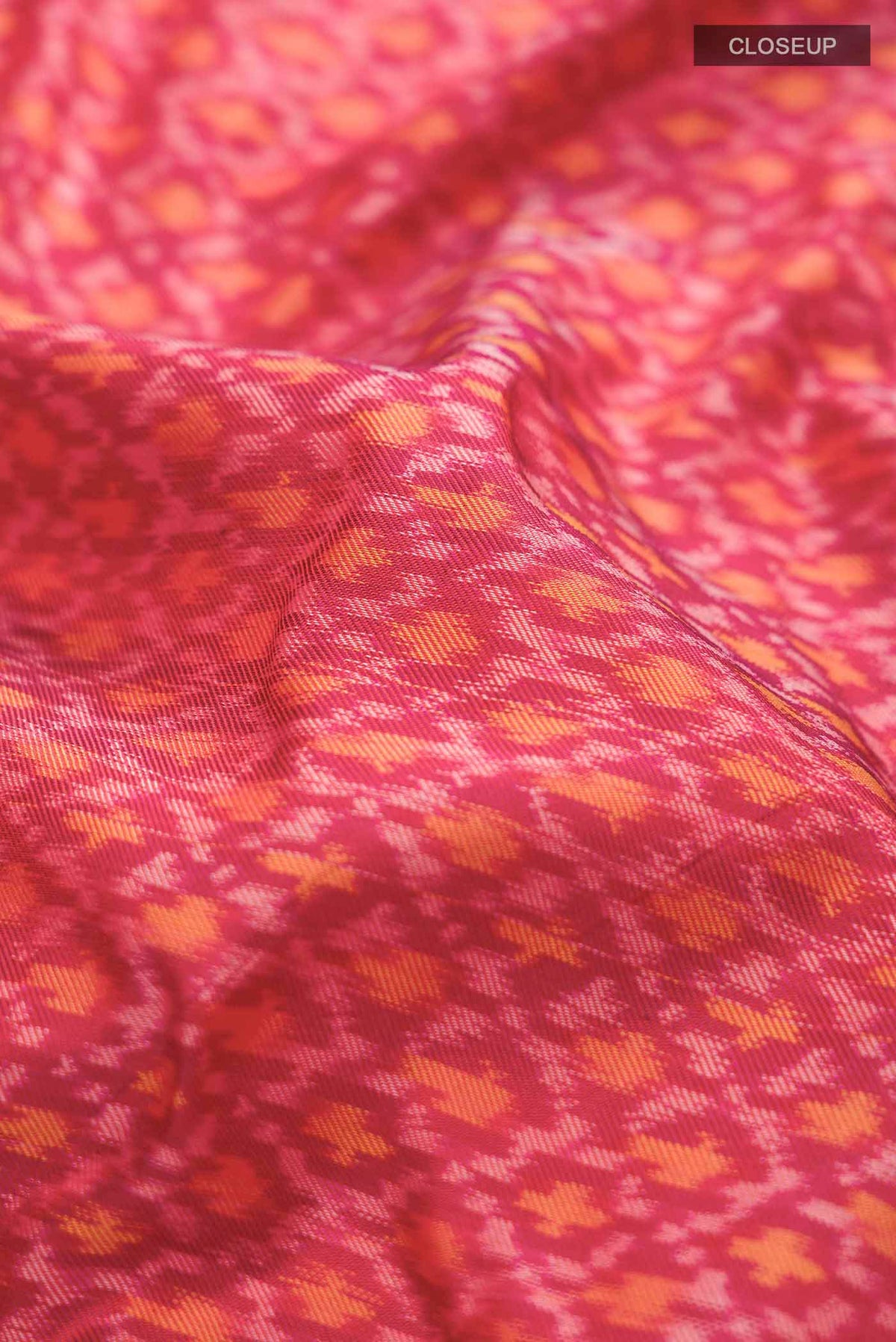 Close up of Red Rajkot Patola Silk Saree with Pure Ikat on the body and Plain Border displaying folds