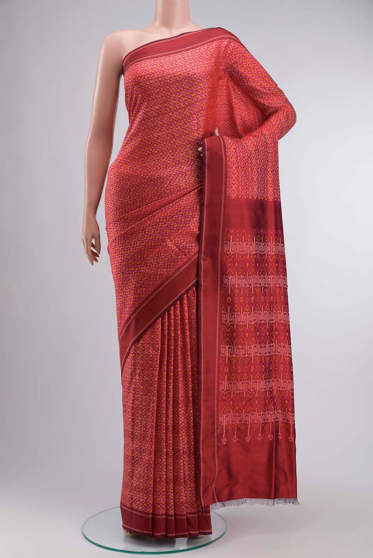 Red Rajkot Patola Silk Saree with Pure Ikat on the body and Plain Border displayed on a mannequin