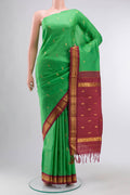 Green Kanchipuram Silk Saree with Zari Butta on the body and One Side Border displayed on a mannequin