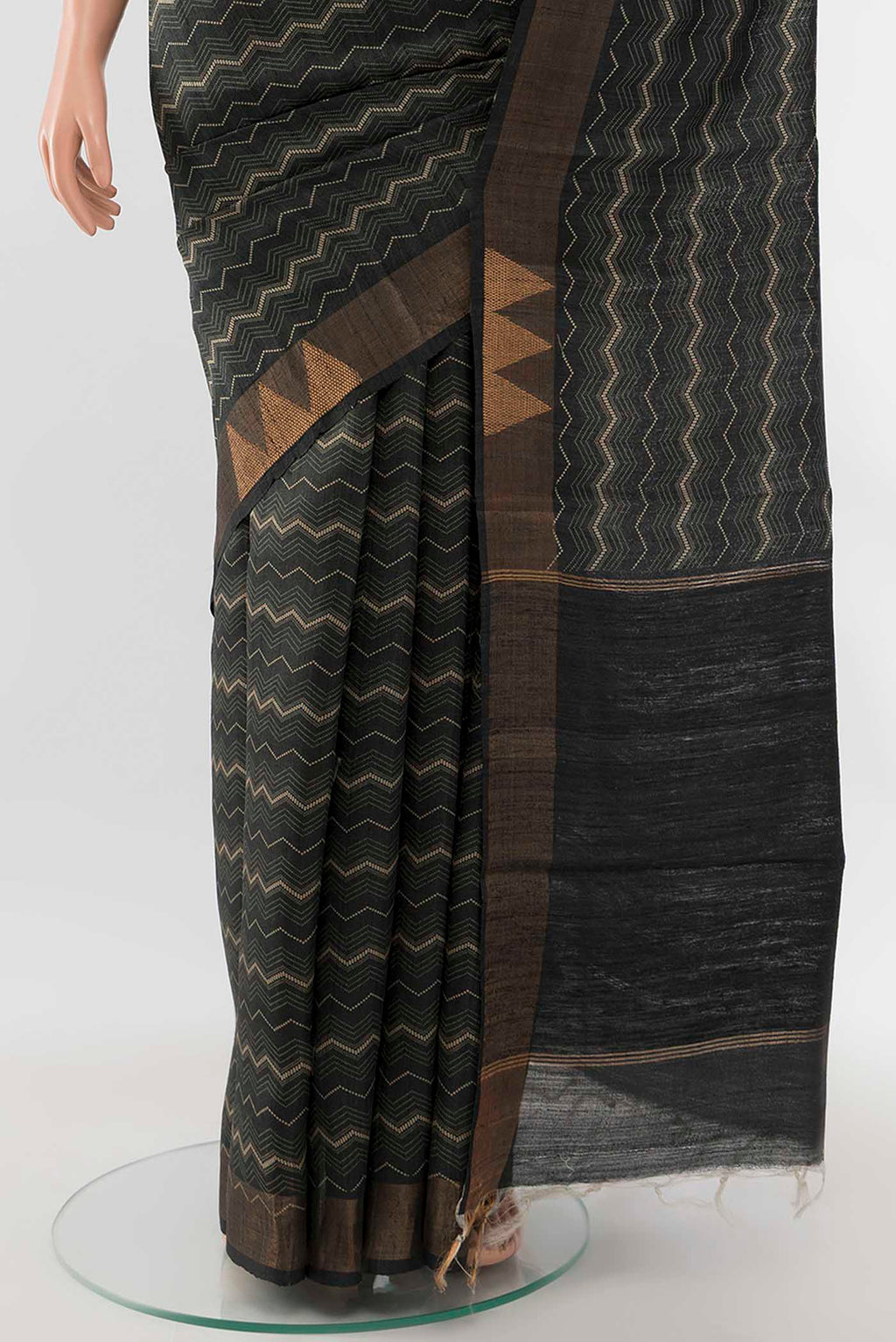 Pleats and pallu of Black Tussar Silk Saree with Zari Butta on the body and Silk Border