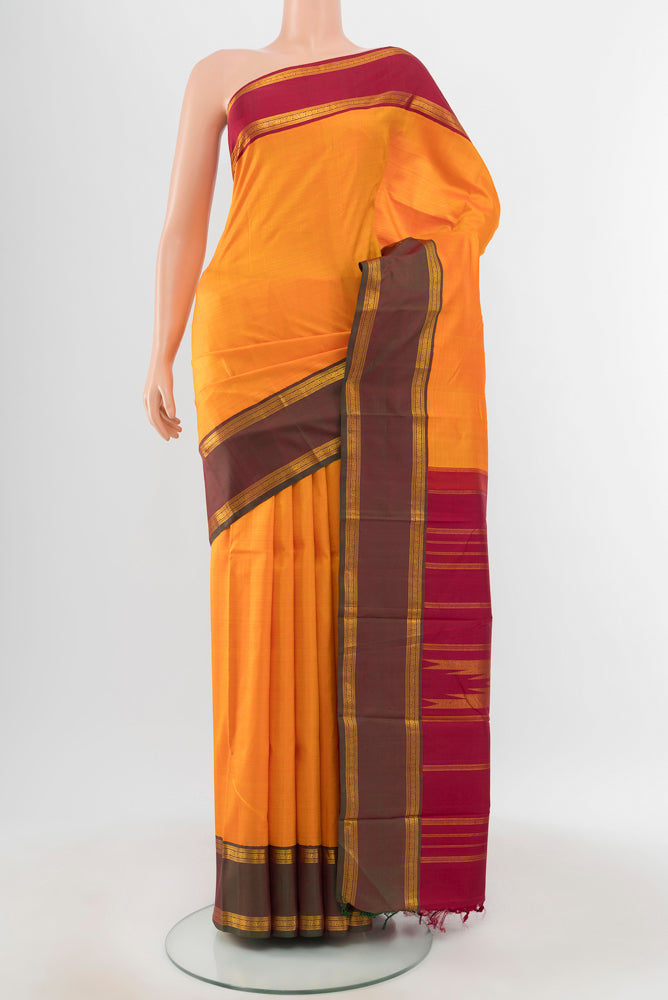 Pure Silk Pure Zari Yellow Kanchipuram Saree with Zari Butta on the body and Silk Border.  displayed on a mannequin