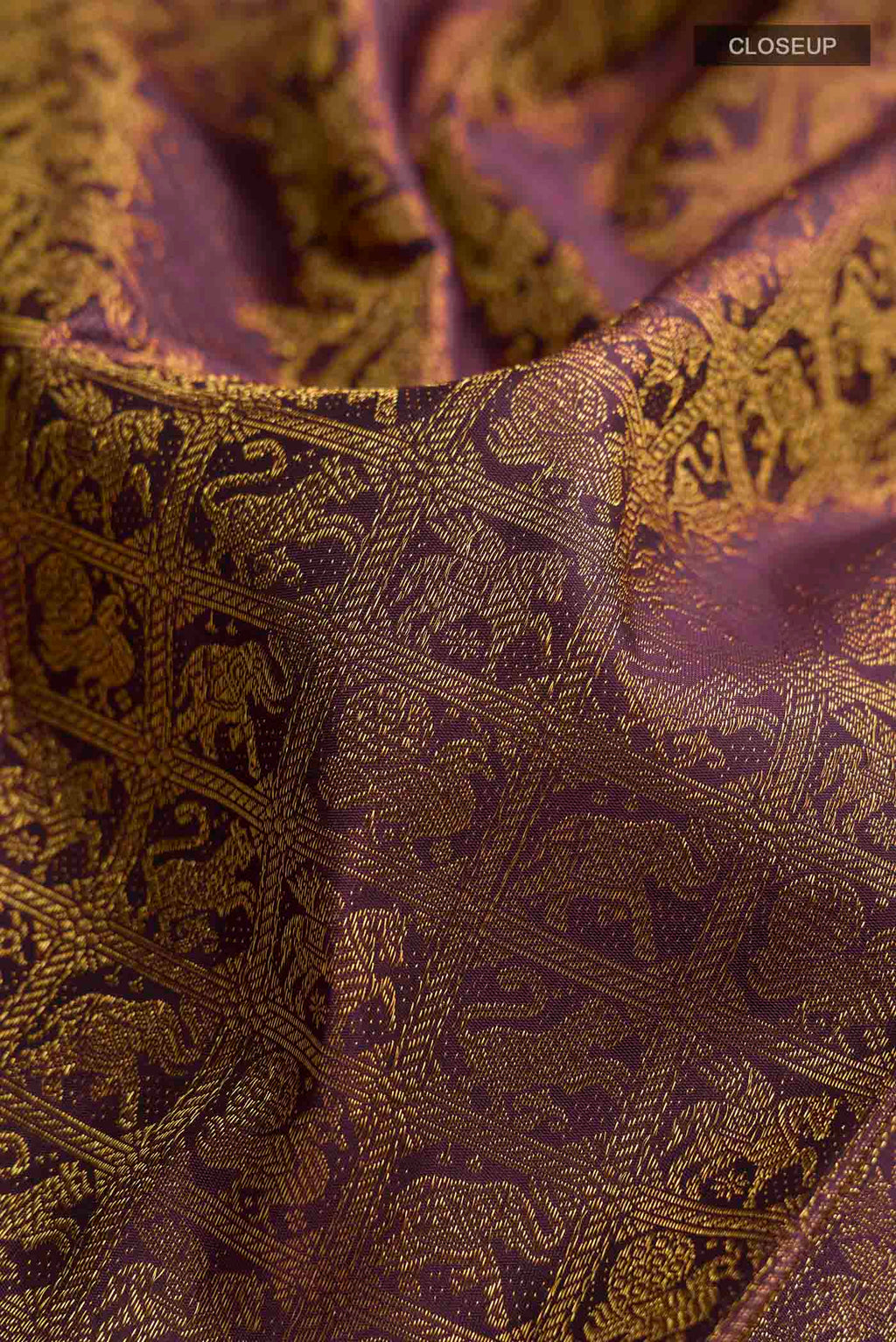 Close up of Burgundy Kanchipuram Silk Saree with Zari Brocade on the body and Zari Border displaying folds