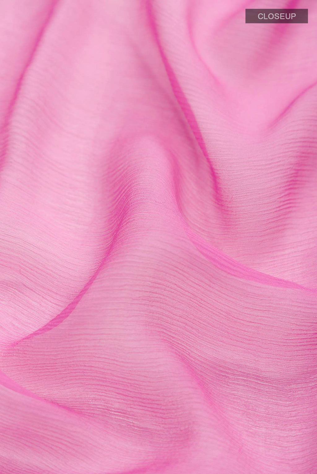 Close up of Pink Chiffon Saree with Plain Body and Zari Border displaying folds