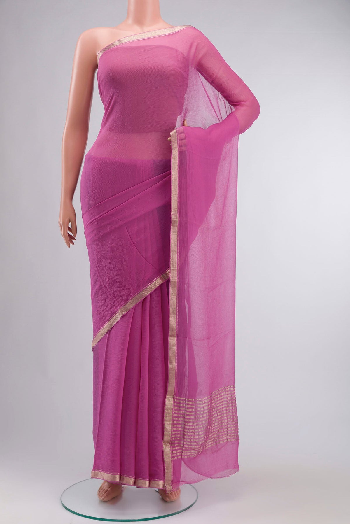 Pink Chiffon Saree with Plain Body and Zari Border displayed on a mannequin