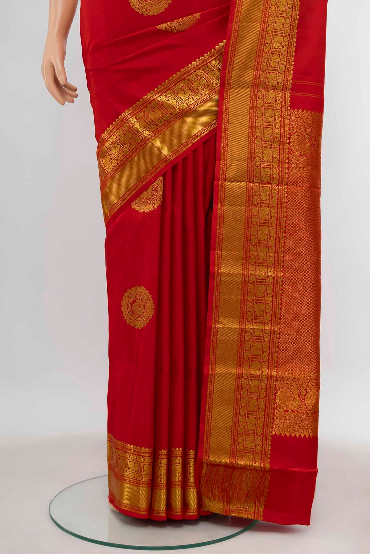 Pleats and pallu of Red Kanchipuram Silk Saree with Zari Butta on the body and Zari Border