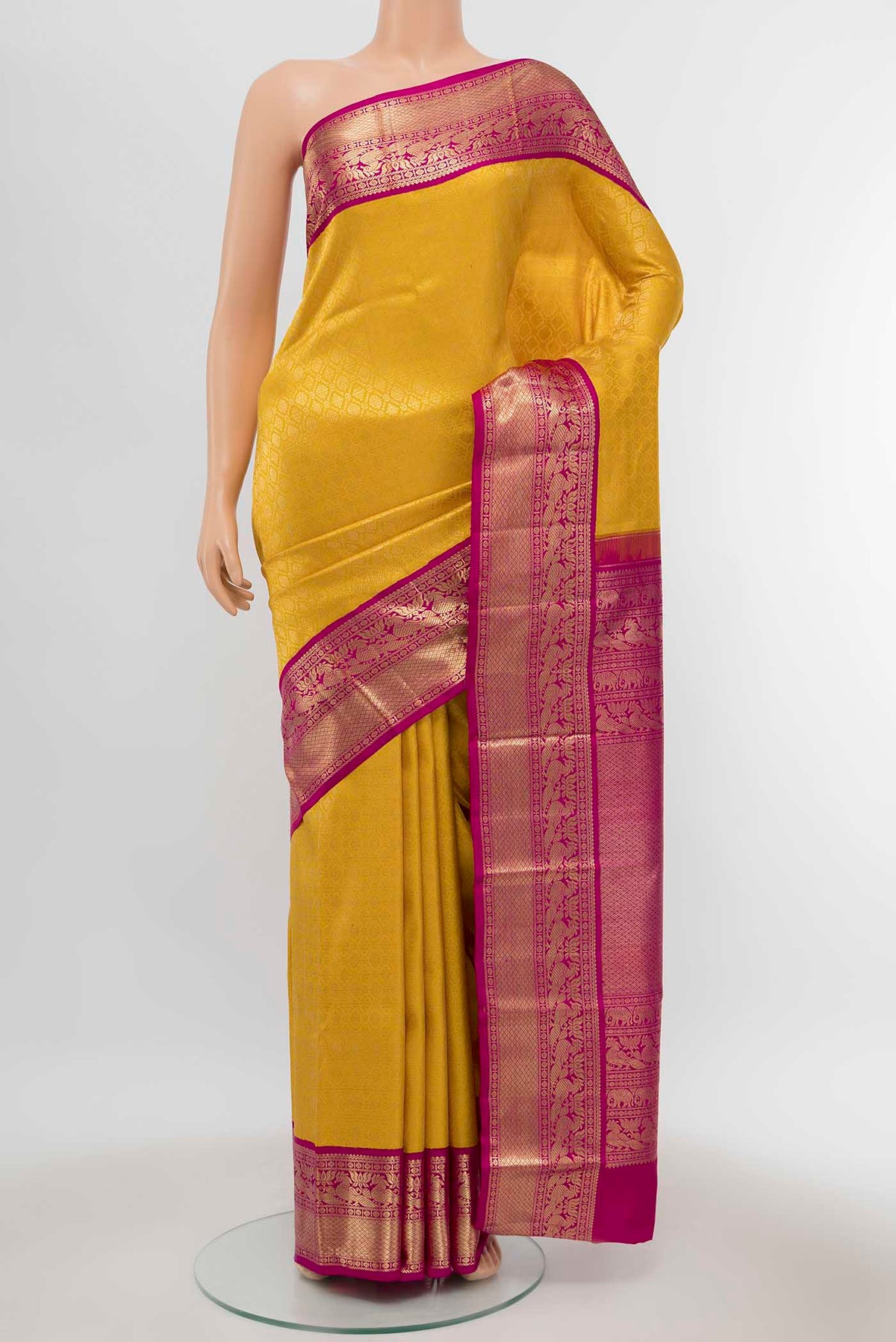 Yellow Kanchipuram Silk Saree with Zari Brocade on the body and Silk Border displayed on a mannequin