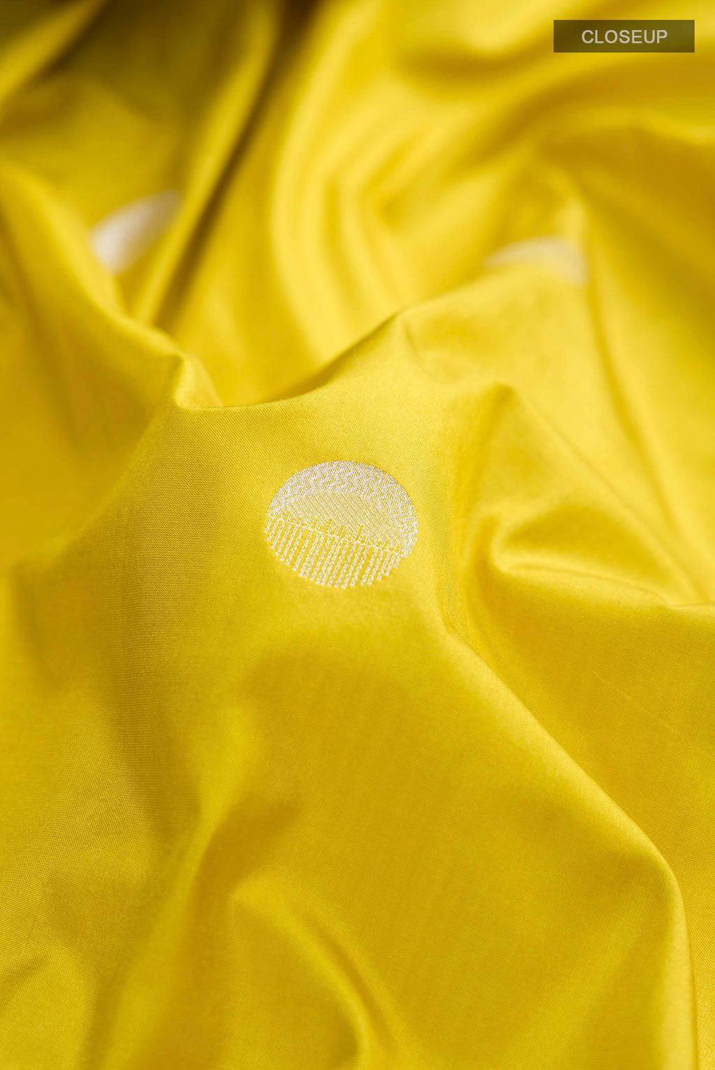 Close up of Yellow Banarasi Silk Saree with Zari Butta on the body and Zari Border displaying folds