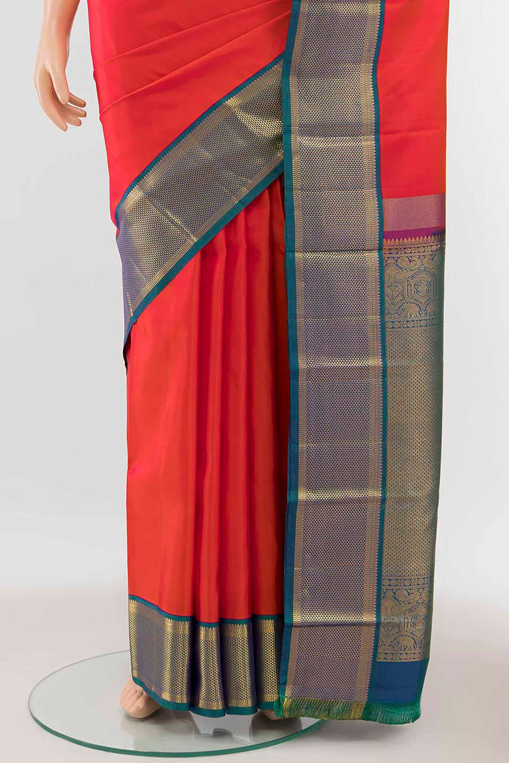 Pleats and pallu of Orange Kanchipuram Silk Saree with Zari Butta on the body and Silk Border