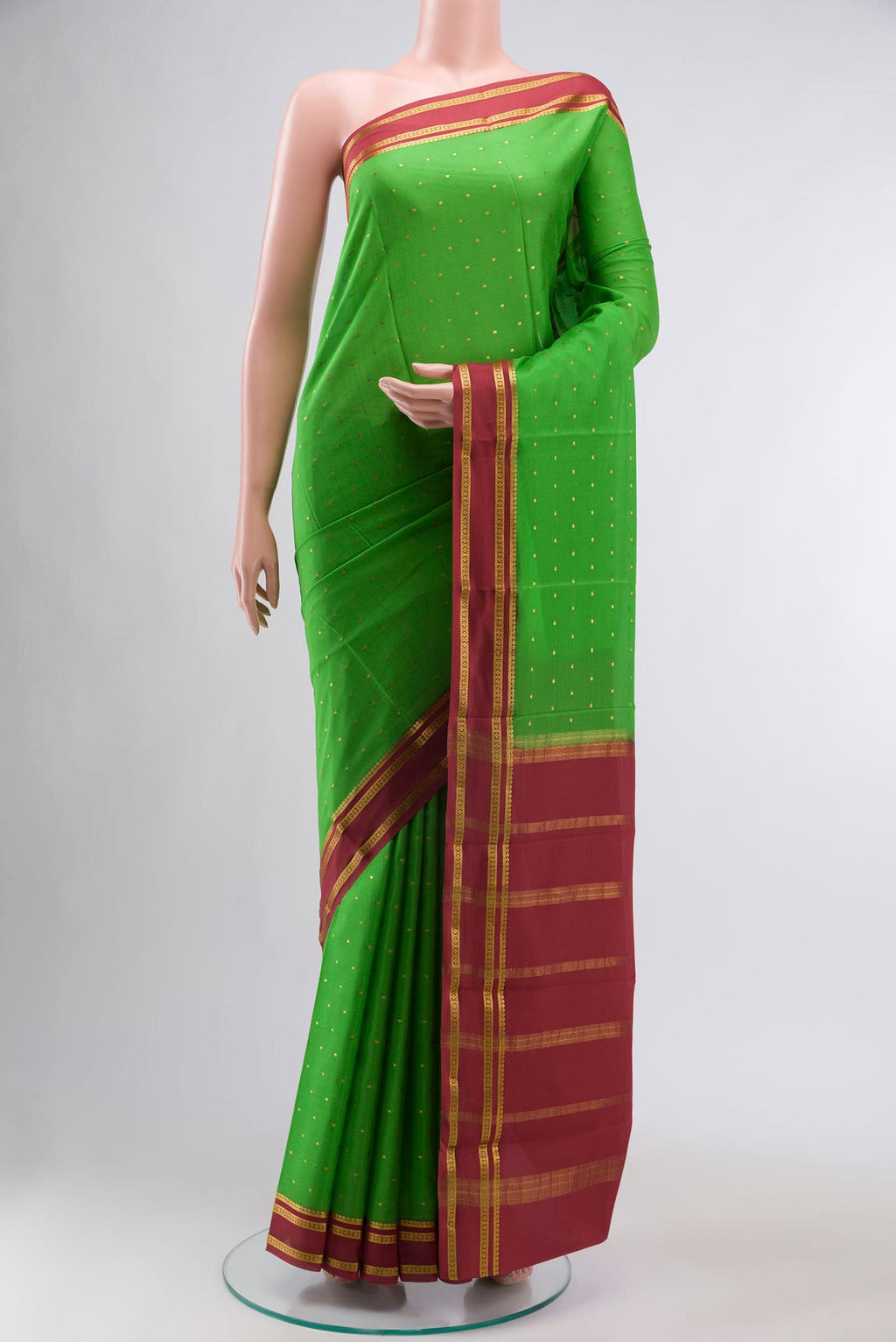 Green Mysore Crepe Saree with Zari Butta on the body and Zari Border displayed on a mannequin