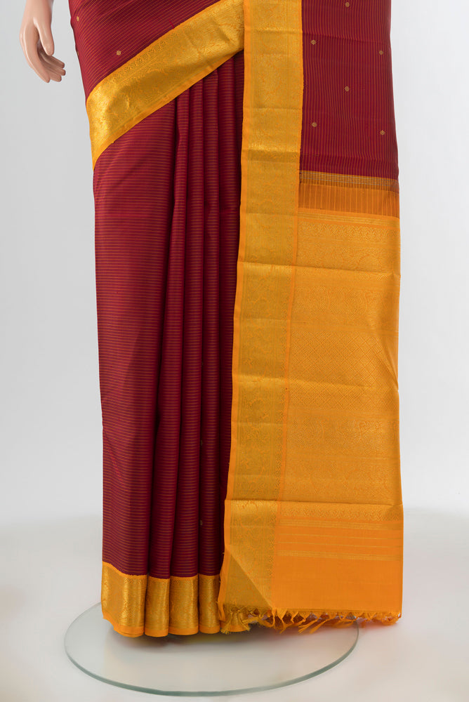 Pleats and pallu of Pure Silk Pure Zari Red Kanchipuram Saree with Zari Butta on the body and Zari Border. 
