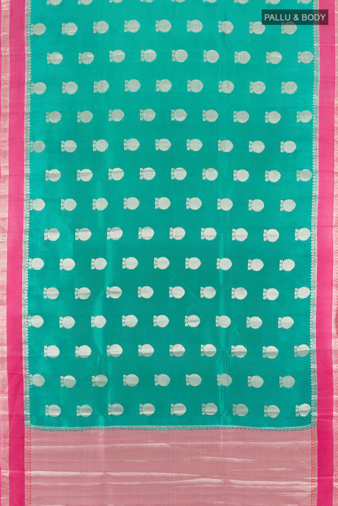 Flat view of Light Blue Tussar Silk Saree with Zari Butta on the body and Silk Border. 