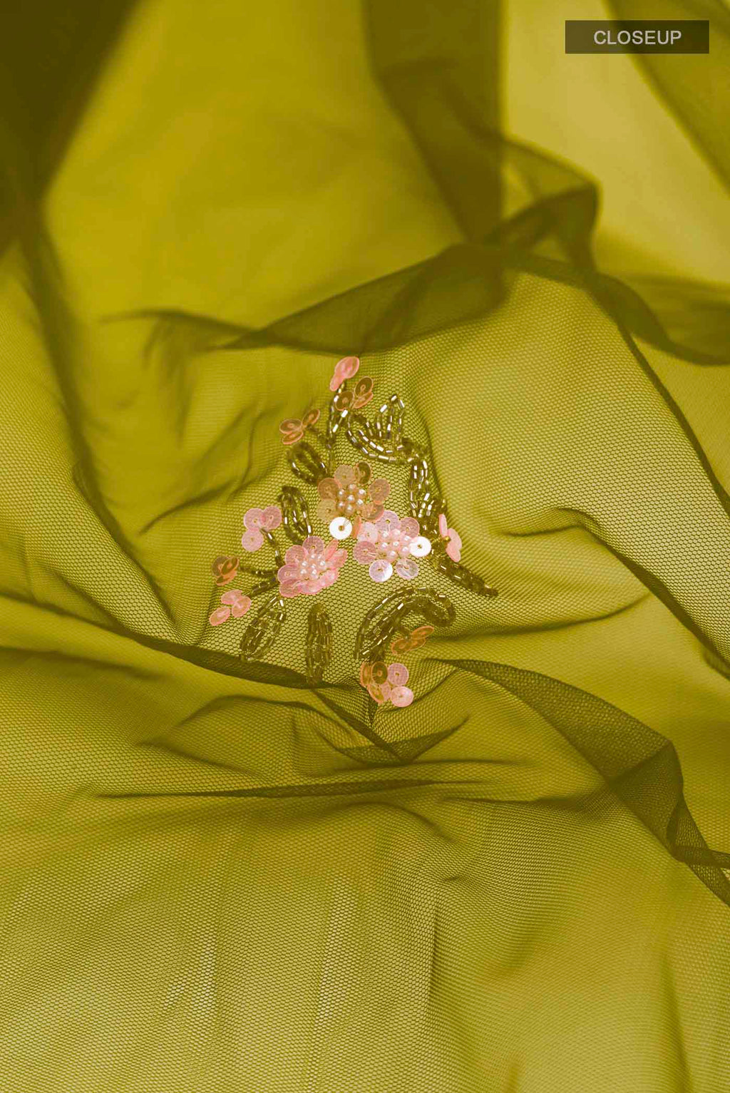 Close up of Green Embroidery Net Saree with Embroidery on the body and Embroidery Border displaying folds