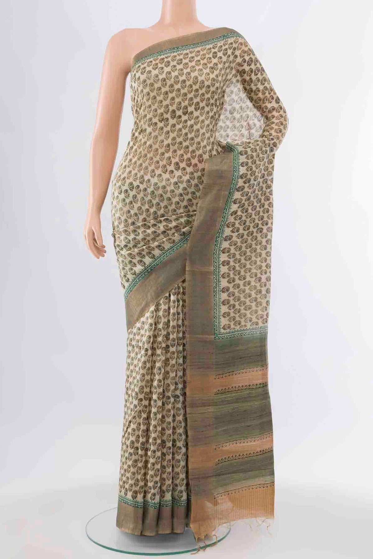 Beige Tussar Silk Saree with Floral Print on the body and Zari Border displayed on a mannequin
