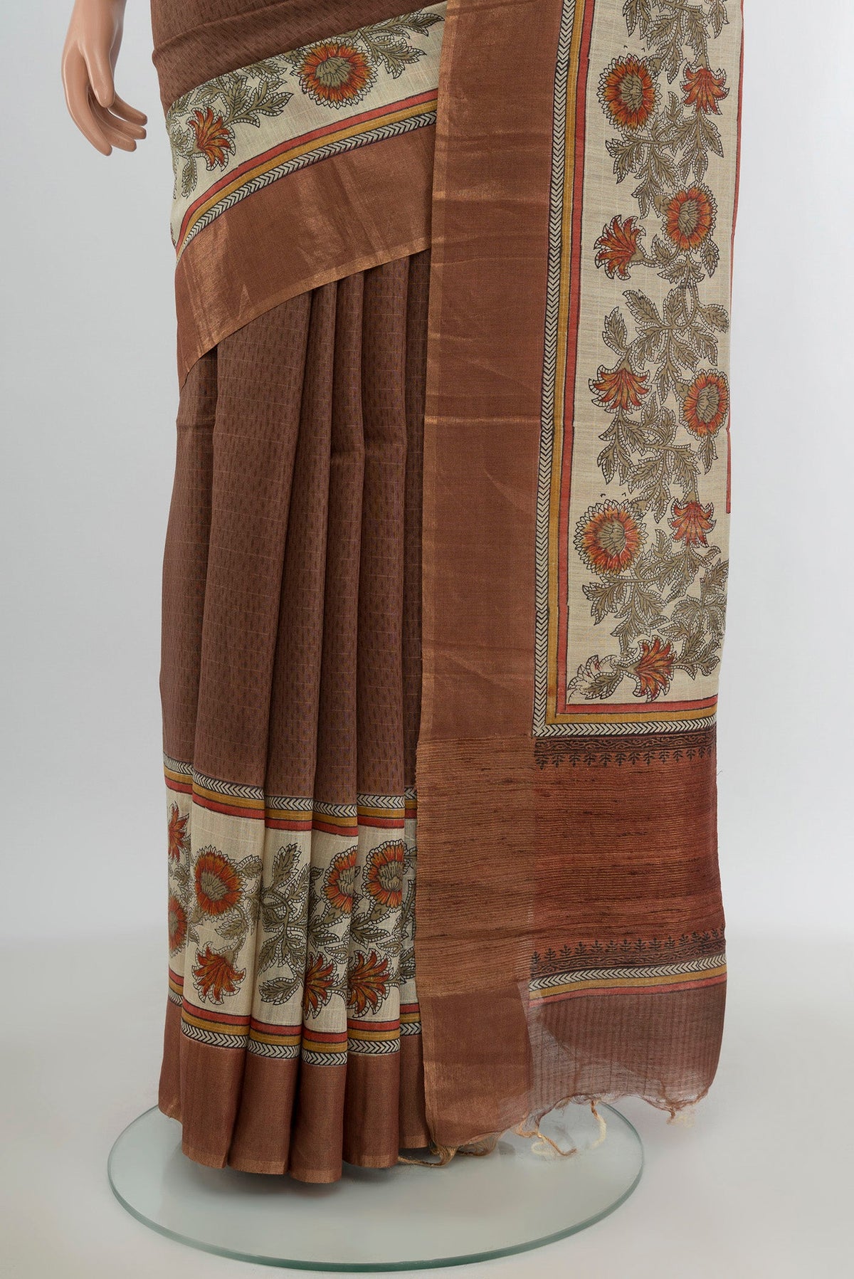 Pleats and pallu of Brown Tussar Silk Saree with Printed design on the body and Printed Border. 