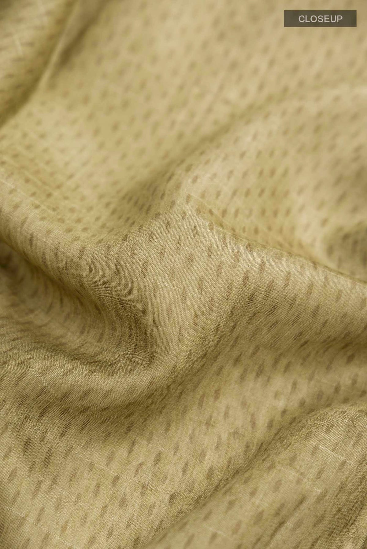Close up of Green Bhagalpuri Tussar Silk Saree With Printed design on the body and Zari Border displaying folds