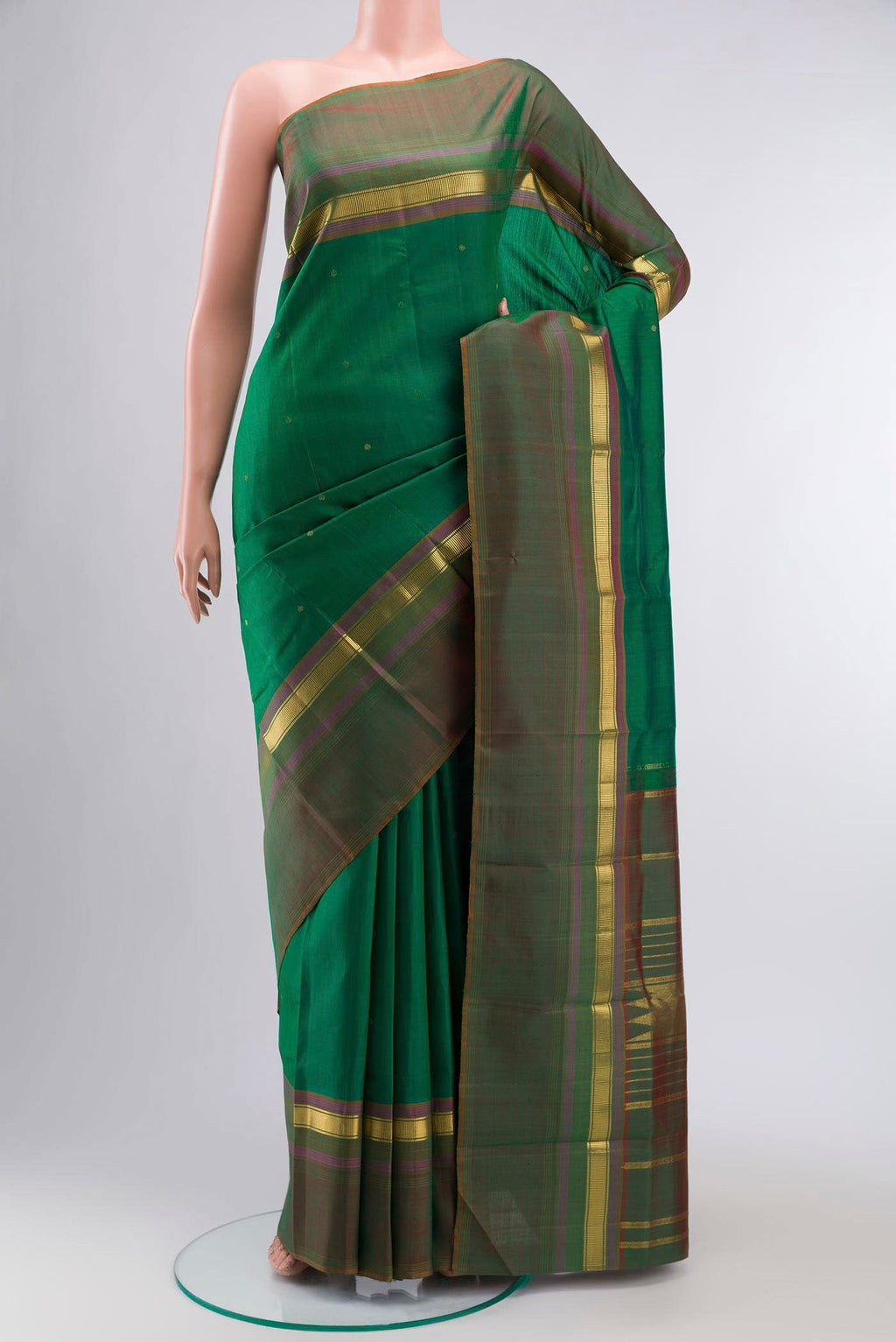 Green Kanchipuram Silk Saree with Zari Butta on the body and Zari Border displayed on a mannequin