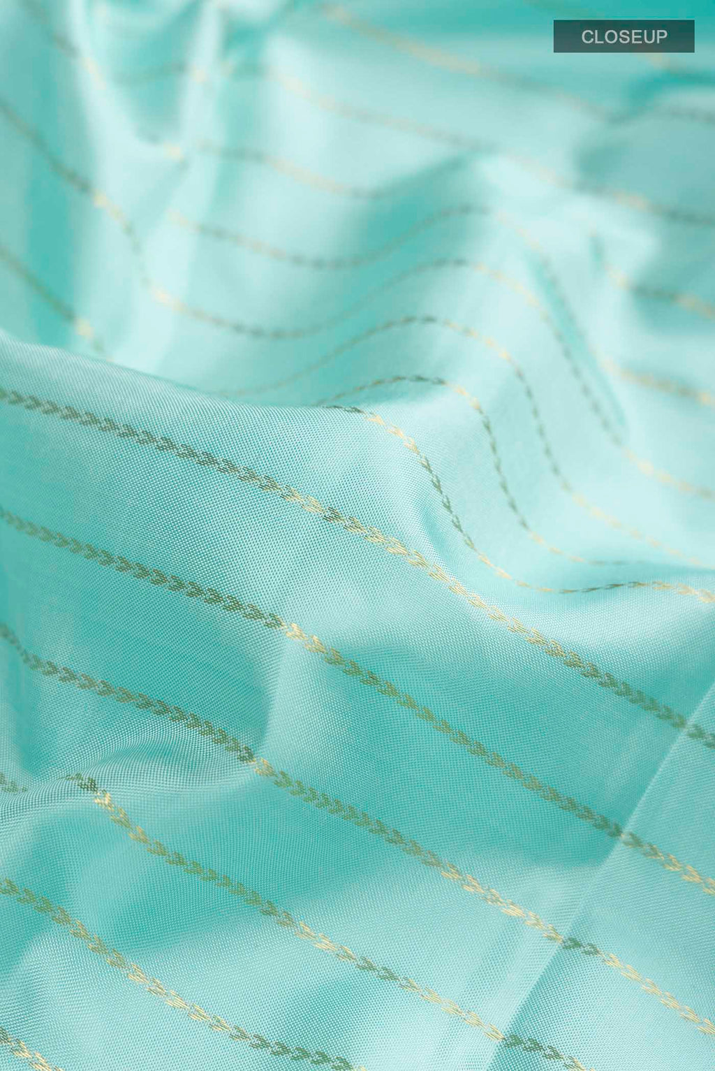 Close up of Pure Silk Pure Zari Turquoise Kanchipuram Saree with Zari Butta on the body and Zari Border displaying folds