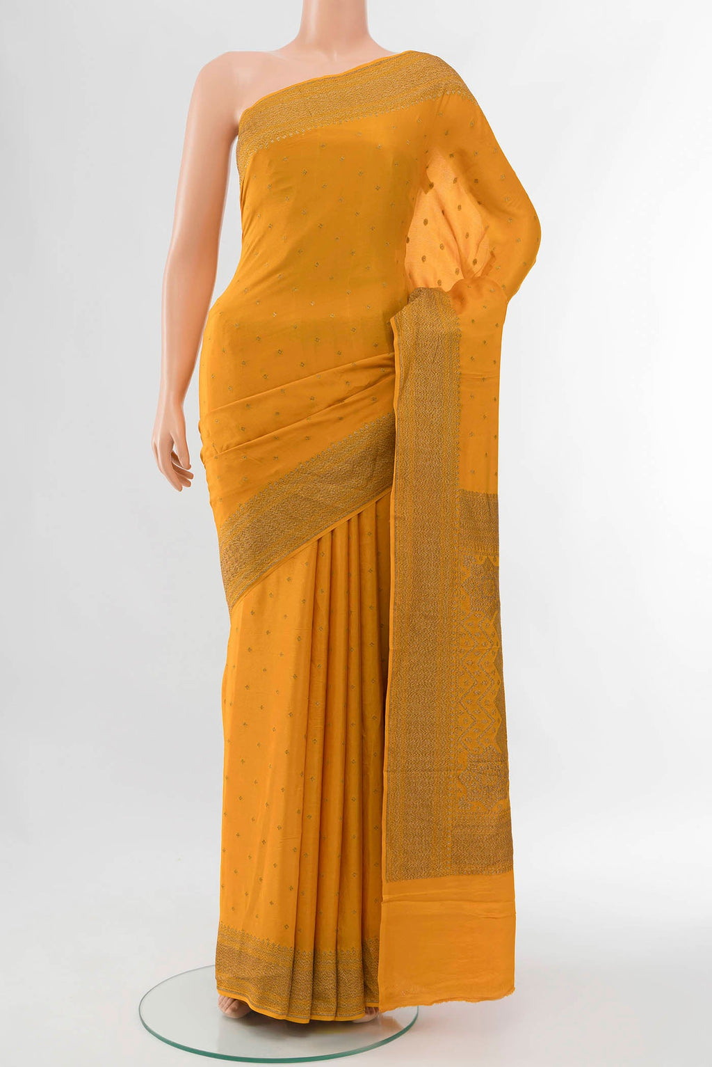 Orange Mysore Crepe Saree with Zari Butta on the body and Zari Border displayed on a mannequin