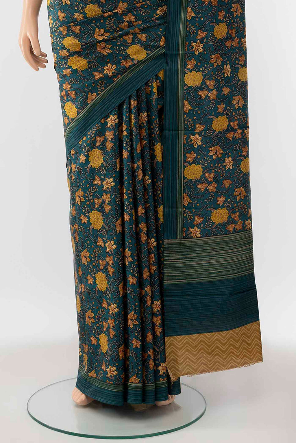 Pleats and pallu of Peacock Blue Printed Silk Saree with Floral Print on the body and Silk Border