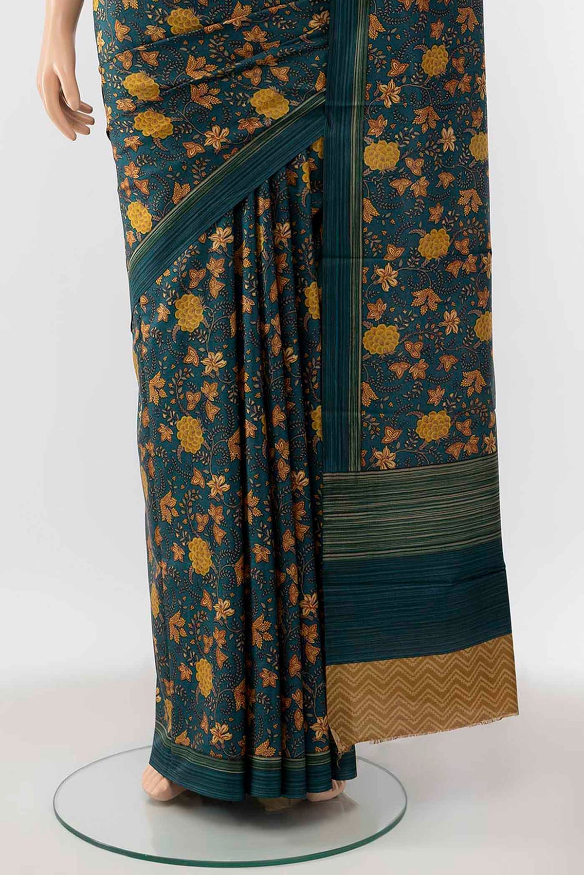 Pleats and pallu of Peacock Blue Printed Silk Saree with Floral Print on the body and Silk Border