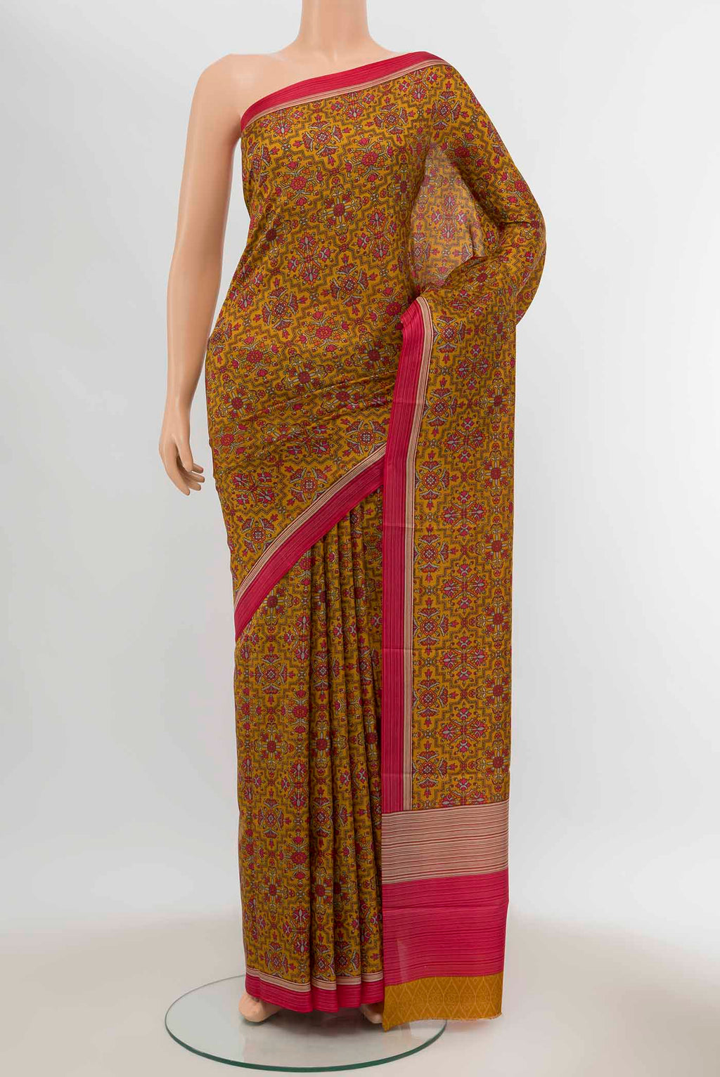 Mustard Printed Silk Saree with Floral Print on the body and Silk Border displayed on a mannequin
